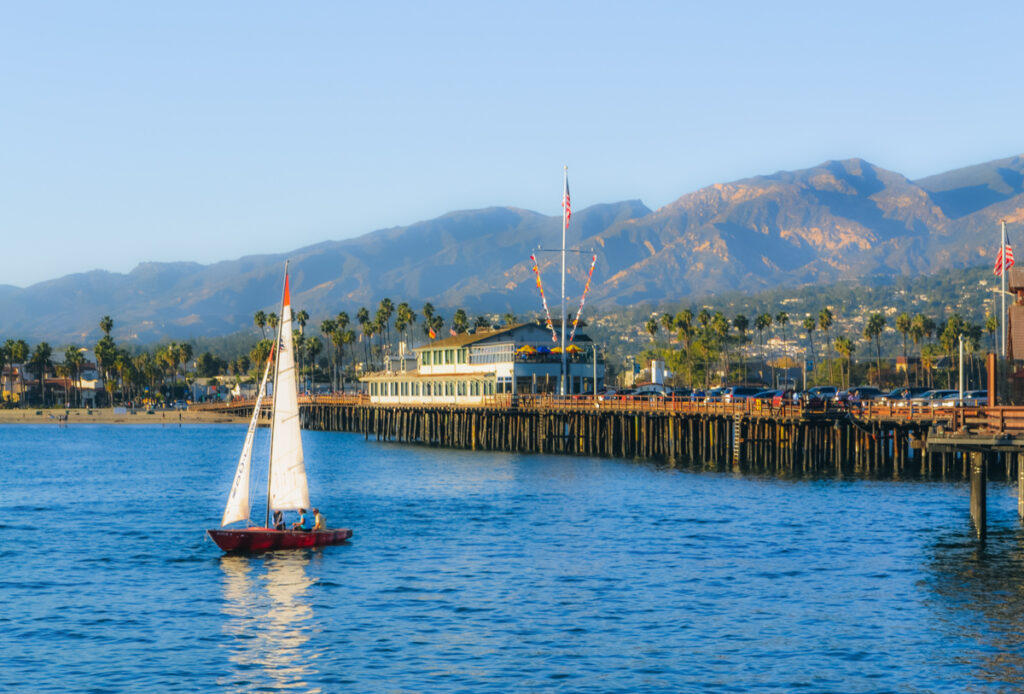 Stearns Wharf Santa Barbara with a sailboat in the water