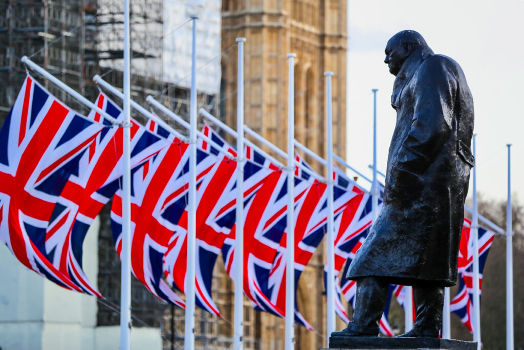 Statue of Churchill and British flags outside Churchill War Rooms