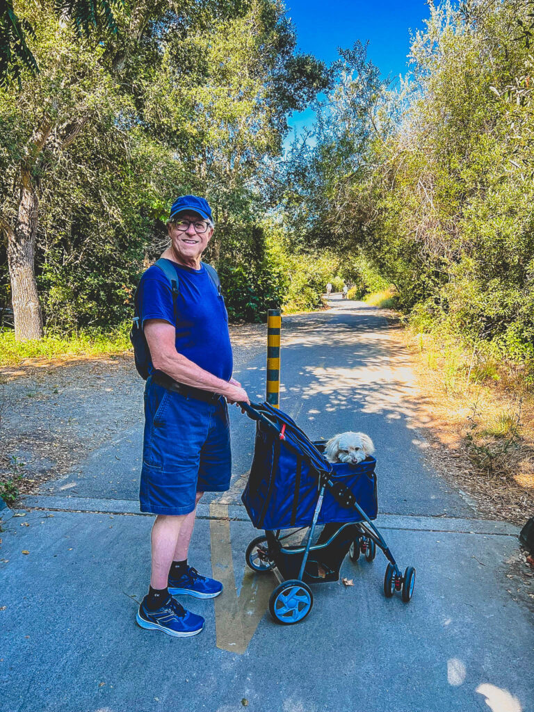 Man with his puppy in a stroller walking the Bob Jones Trail near Arroyo Grande
