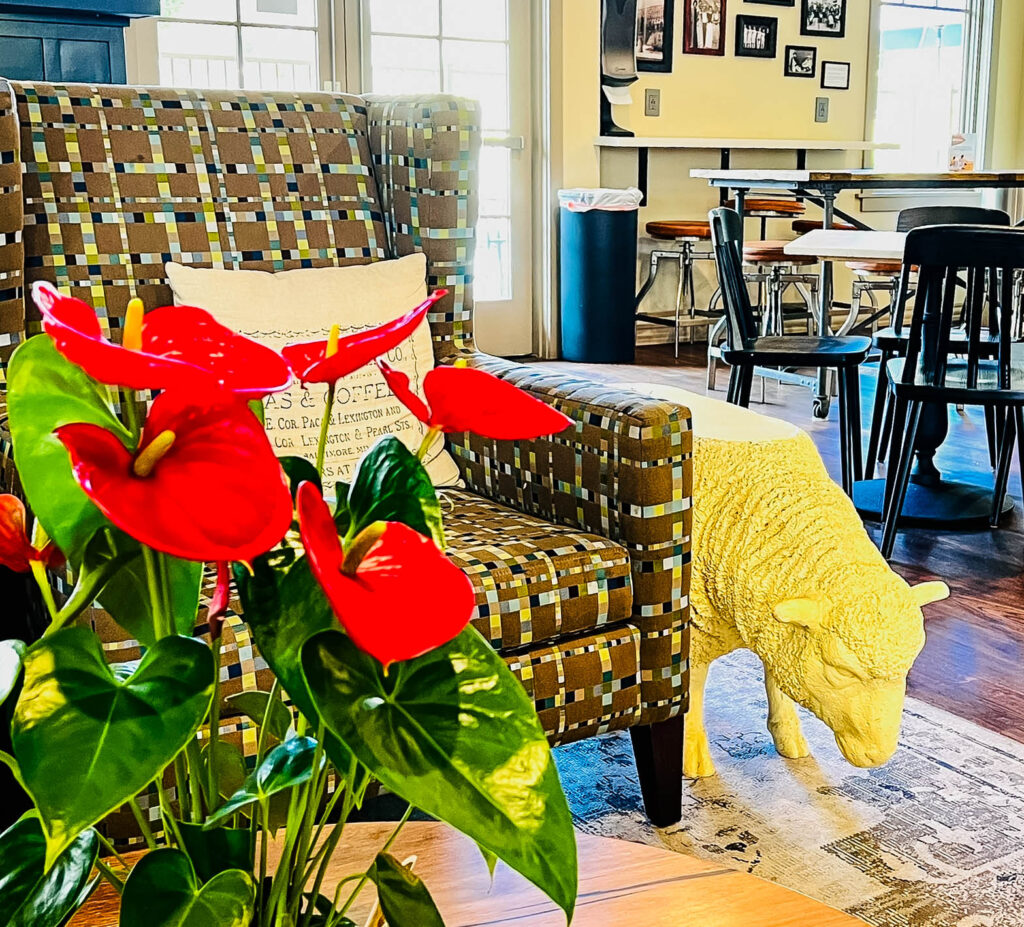 Lobby of Agrarian Hotel in Arroyo Grande with flowers and a sheep end table