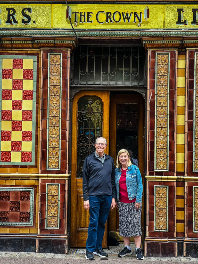 Two people in front of the Crown Bar in Belfast