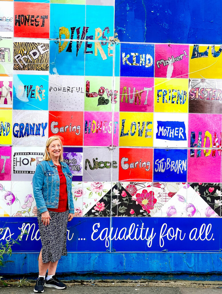 Women's Quilt Mural in West Belfast with visitor