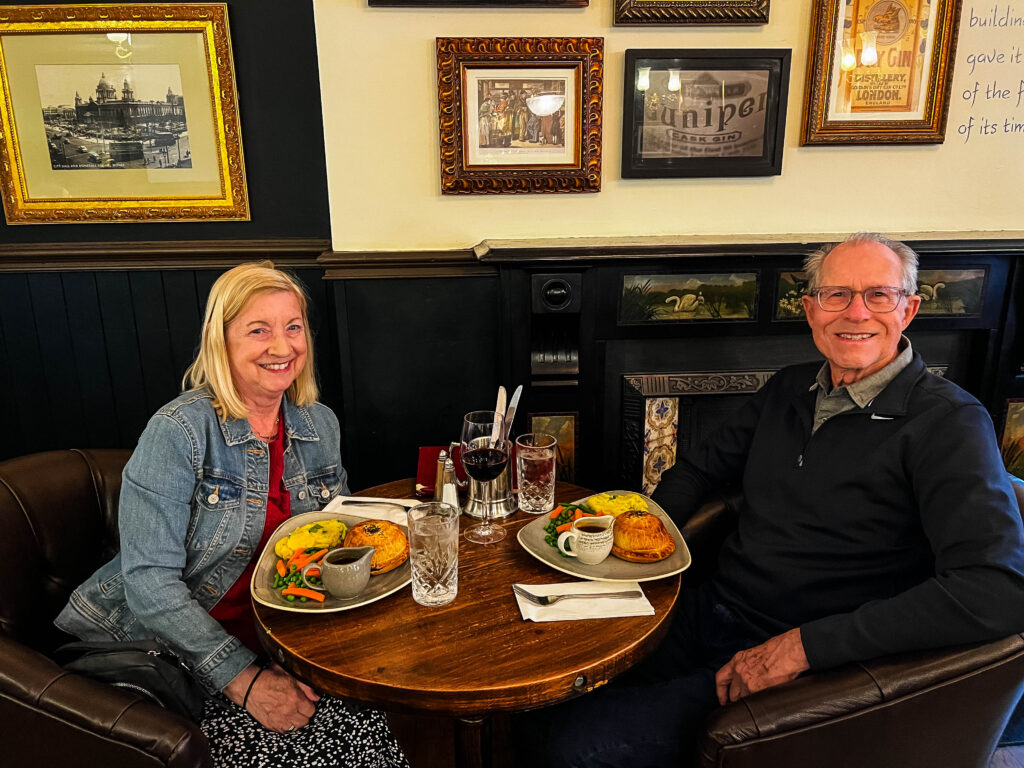 Two people eating dinner at the Crown Pub in Belfast