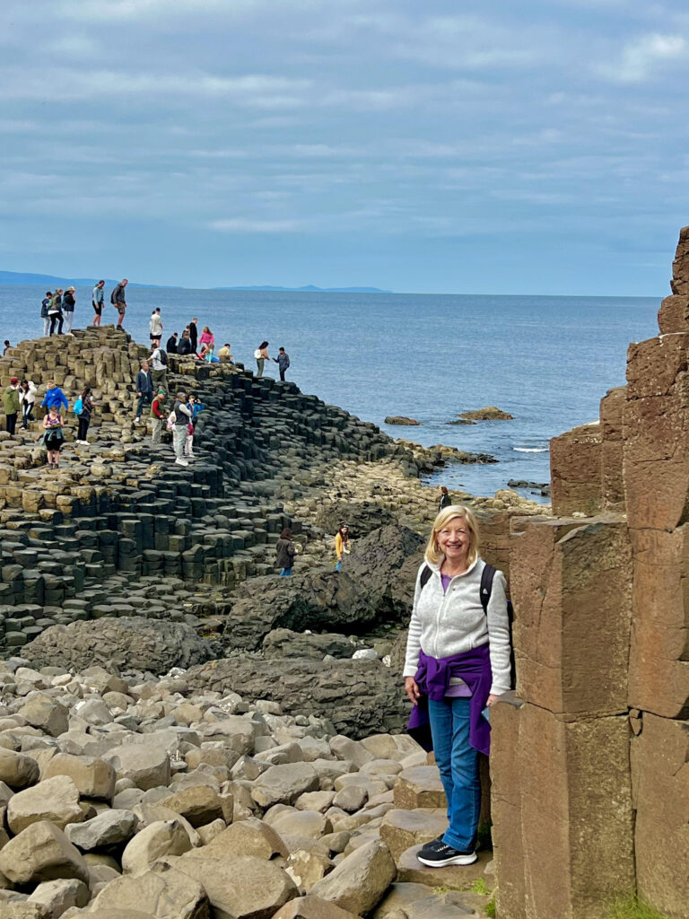 Author climbing columns at Giants Causeway